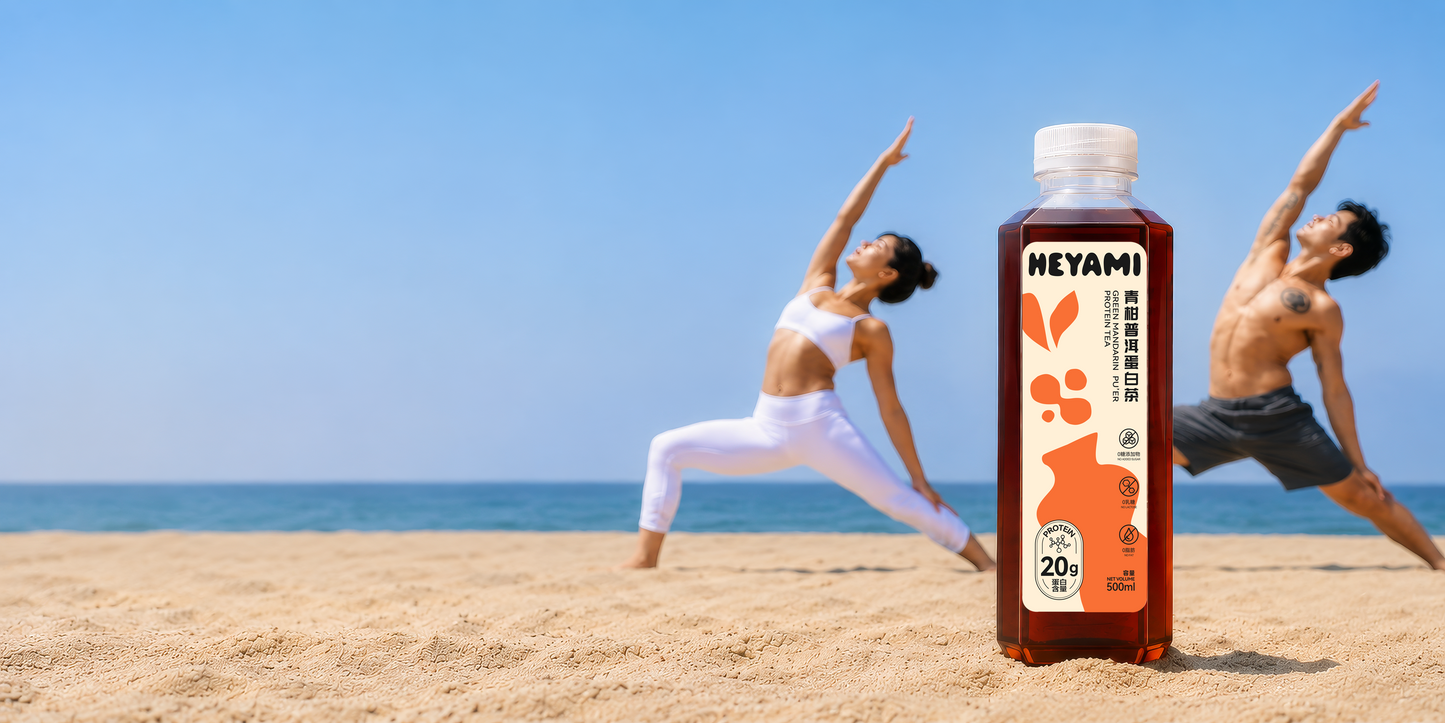 Two people practicing yoga on a beach with a bottle of NEYAMI drink in the foreground.